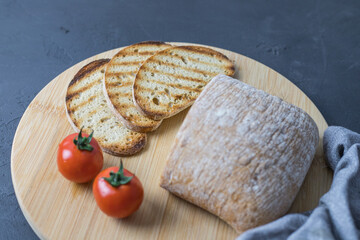 Grilled slices of bread lying on a wooden kitchen board