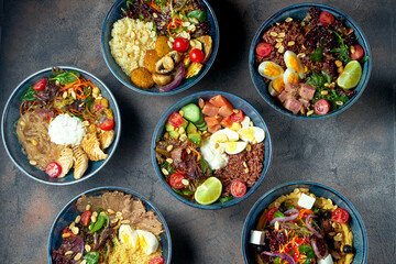 Set of different buddha bowls with seafood, meat and veggie with falafel. Healthy food. Photo for the menu. Top view, flat lay