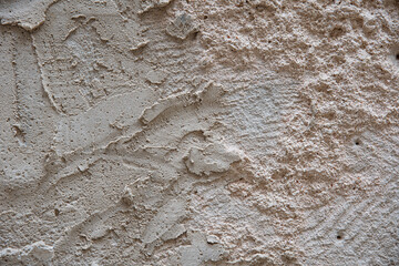 Vintage grunge texture of old weathered dirty wall. Painted cracked walls, textured in cracks and drips of paint. Unique scenic unusual background. Cement wall with stain marks. A texture of an old