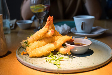 Chicken in tempura on a table in a restaurant.