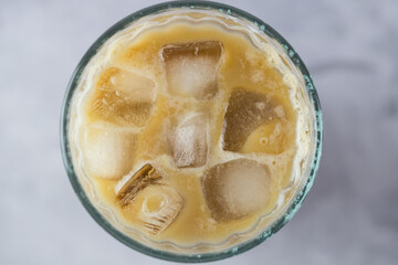 Iced coffee with pieces of ice. Top view.