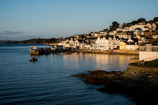 View along the seawall and facades of houses in Saint Mawes, Cornwall, UK.