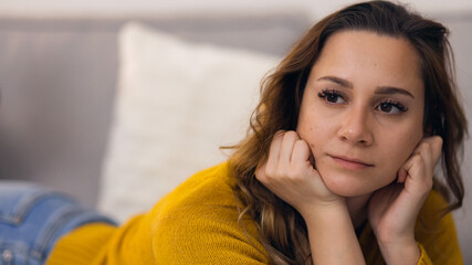 Young relaxed woman on the couch in her appartment - home shooting