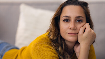 Young relaxed woman on the couch in her appartment - home shooting