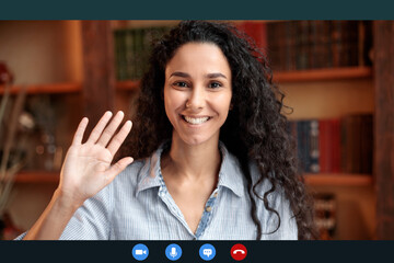 Woman waving to camera having online conference call