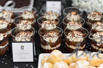 Yummy layered chocolate desserts on a candy bar at the glamour wedding party, front view