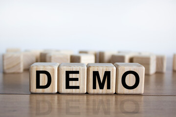 Demo symbol. Concept word 'demo' on cubes on a beautiful wooden table. White background. Business...