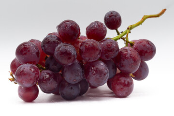 Fototapeta premium Bunch of red grapes on white background