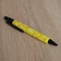 ballpoint pen covered with polymer clay lemon and orange pattern