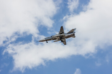 Fototapeta na wymiar military plane in the blue clear sky on a sunny day.