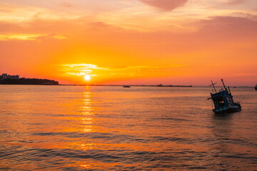 Naklejka na ściany i meble an old ship during the sunset on the sea in the Gulf of Thailand