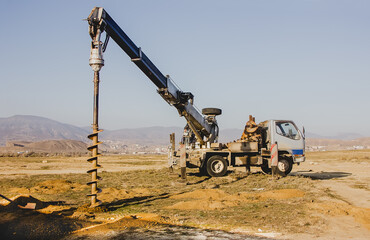 Drilling Rig Makes Pole Pits in the Valley