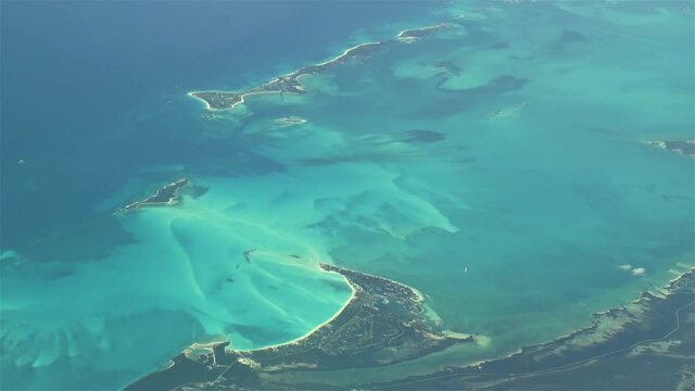 Flying over The Bahamas. Beautiful ocean colors. Actual aerial footage.