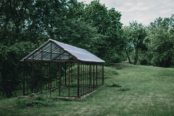 Old greenhouse structure with new plastic roof