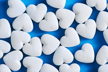 heart-shaped tablets. on blue background. medicine, cardiology health