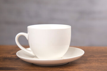 cup of coffee on the wooden background