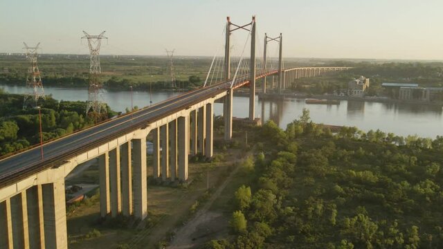 Aerial establishing shot of Zarate Brazo Largo bridge crossing the Parana river at sunset