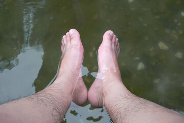 Soaking foot in the water at hot spring foot bath for therapy