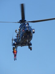Helicopter Super Puma during rescue training operation with rope