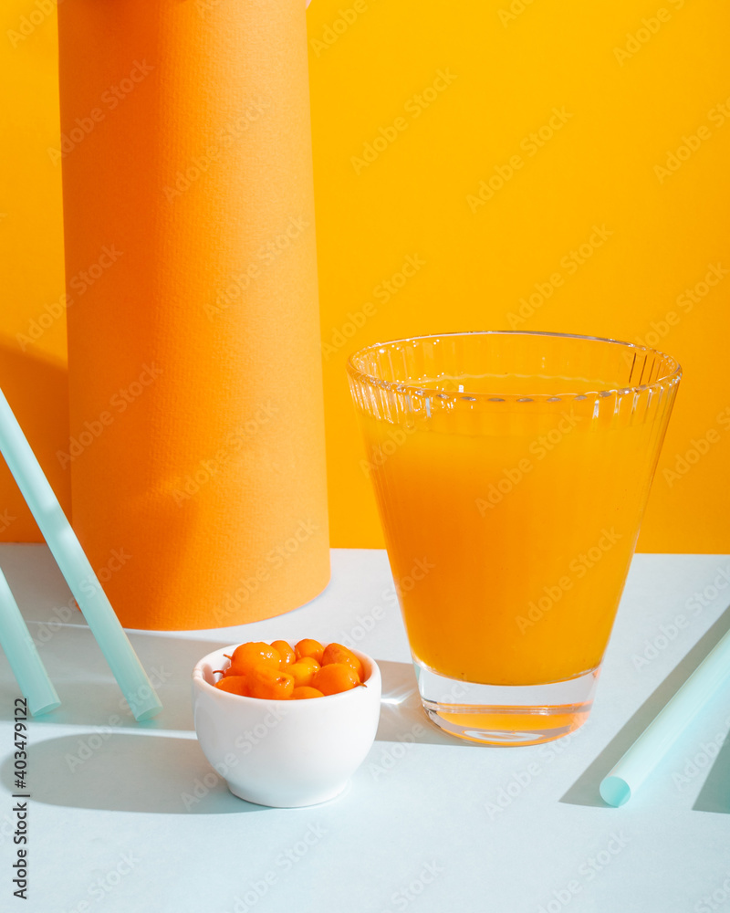 Canvas Prints sea ​​buckthorn healthy drink on orange and blue geometric background