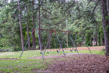 Old worn swing set in the park