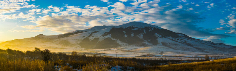 Nature Winter Panorama of Mountain covered with snow and Sunset wide nature image, photo.
