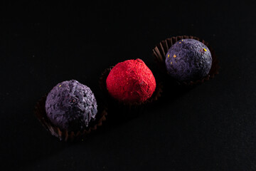 Colored round candies on a dark background