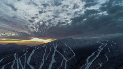 Aerial view to Stowe Mountain Ski Resort in Vermont, USA during sunset time, early winter 2020 season.