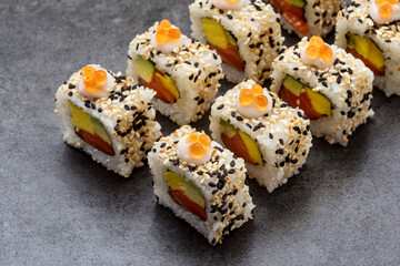 Sushi roll Alaska with tuna fish, avocado, omelette and red caviar
