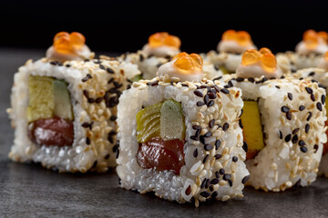 Sushi roll Alaska with tuna fish, avocado, omelette and red caviar