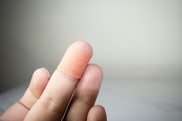 Close up of injured finger with finger plaster adhesive-image