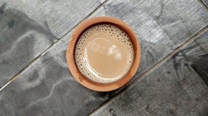 A kulhar or kulhad cup (traditional handle-less clay cup) from North India filled with hot Indian...