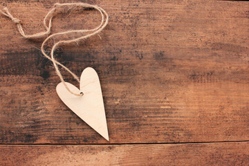 Blank wooden heart for painting or decoupage on wooden table background. Top view. Valentines day concept