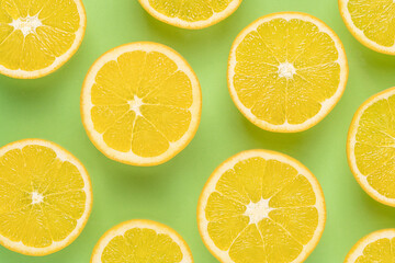 lemon slices on green background.top view food.