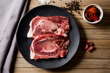 raw beef steak, on a black plate