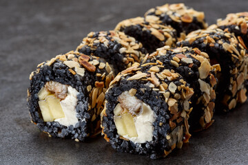 Black rice sushi with eel fish, almong, Philadelphia cheese, and mango