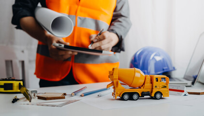 Fototapeta premium Close up of civil male engineer asian working on blueprint architectural project at construction site at desk in office.