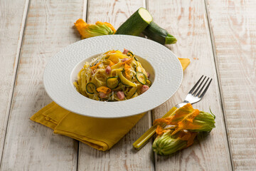 tagliatelle with zucchinis flower bacon and courgettes