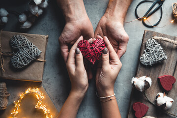 Male hands hold female hands in theirs. Heart in hands. Romance, gifts. Valentine's Day