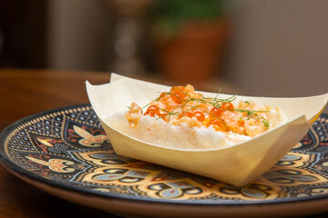 Salmon tartare with salmon roe in the tapioca boat