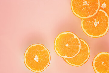 slices of orange .top view.copy space.pink background