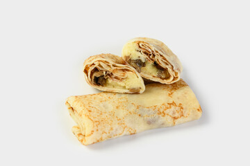 thin pancakes stuffed with potatoes and mushrooms on a light gray background. One pancake is shown in the section. The concept of food delivery services