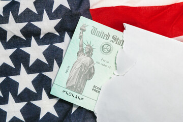 Second round Senate approved of US economic stimulus checks with an American flag during the COVID coronavirus pandemic