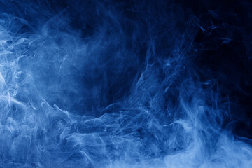 Abstract blue smoke moves on black background. Swirling smoke.