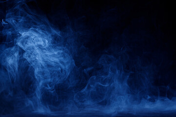 Abstract blue smoke moves on black background. Swirling smoke.