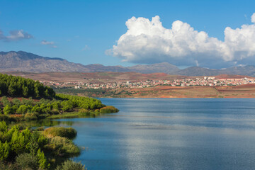 Fototapeta premium Lake and Dam, spring scenery. of Lake and Dam glowing in sunlight