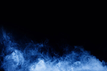 Abstract blue smoke moves on black background. Swirling smoke.