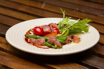 Nicoise salad - salad made with arugula, chopped tomatoes and anchovies.