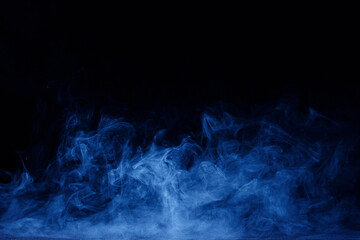 Abstract blue smoke moves on black background. Swirling smoke.