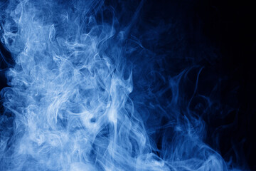 Abstract blue smoke moves on black background. Swirling smoke.